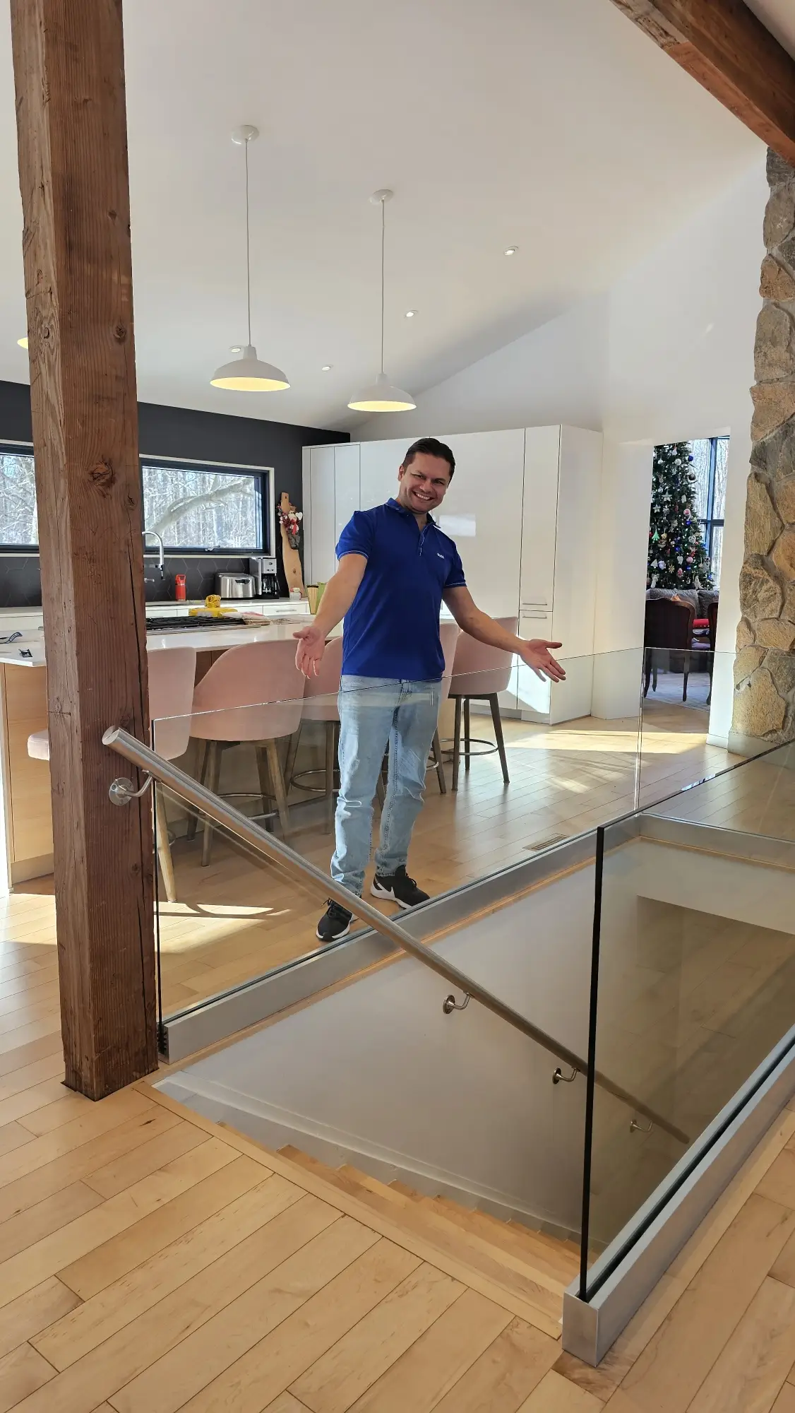 Staircase upgraded with frameless glass railings and a sleek stainless-steel handrail.