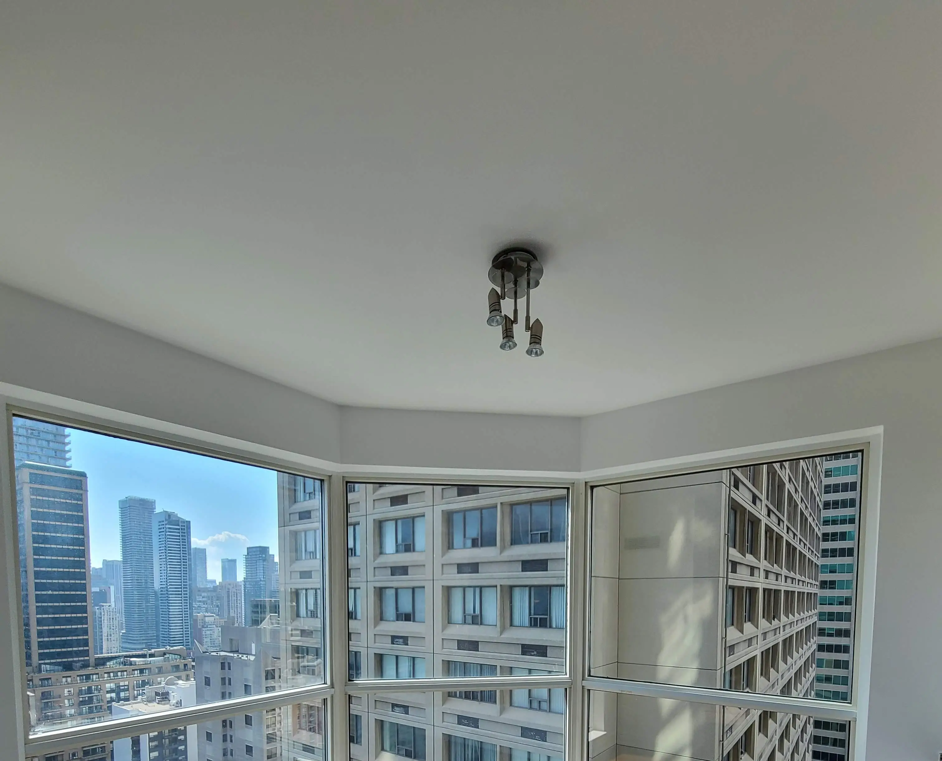 Smooth modern ceiling after professional dust-free popcorn ceiling removal in a renovated GTA home.