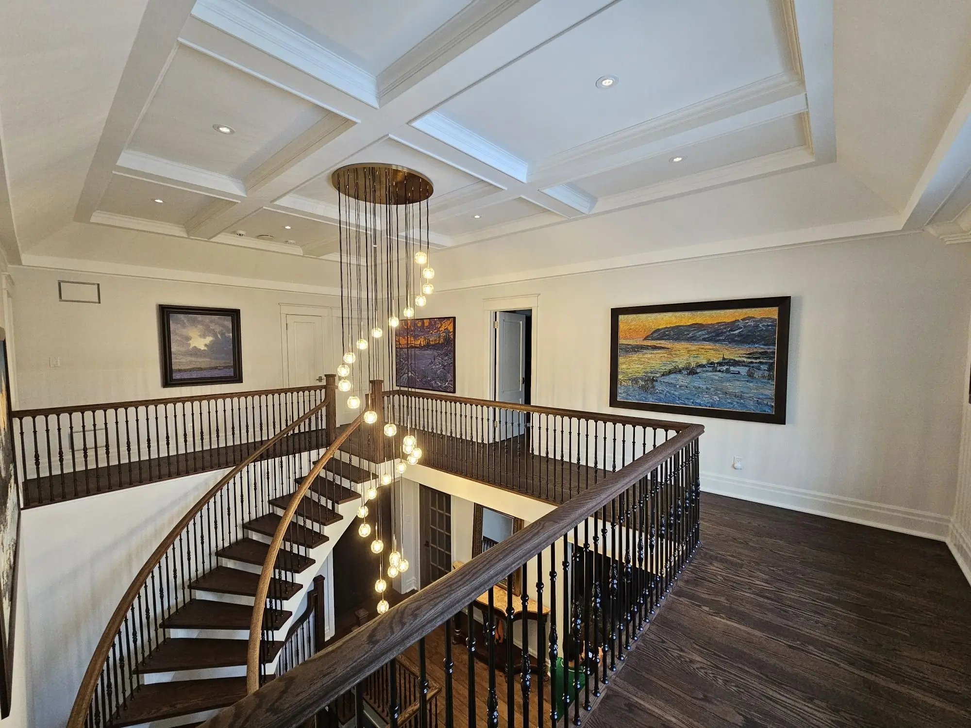 Open-riser staircase renovation in Toronto with custom railing and hardwood finishes.